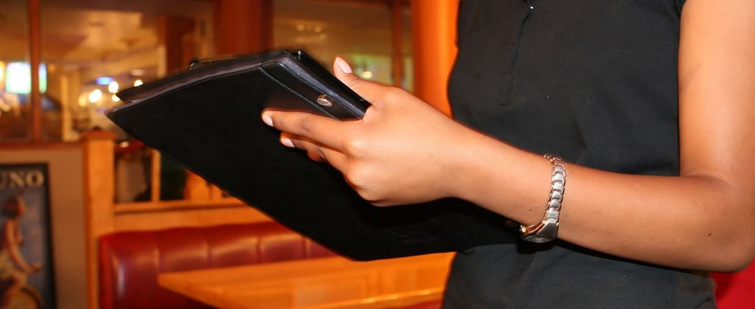 Close up of hospitality staff member taking order